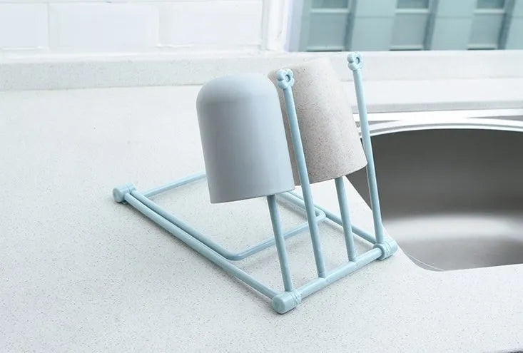 Foldable plastic towel shelf with vertical storage in light pink Nordic kitchen organiser