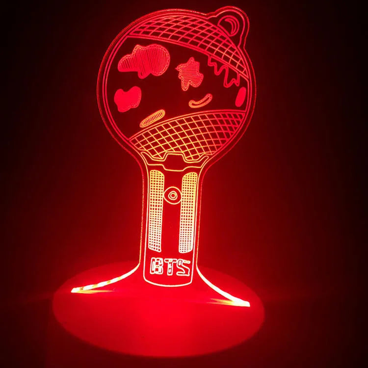 Transparent acrylic display stand showing illuminated BTS Light 101 Tower Gem collectible lamp.