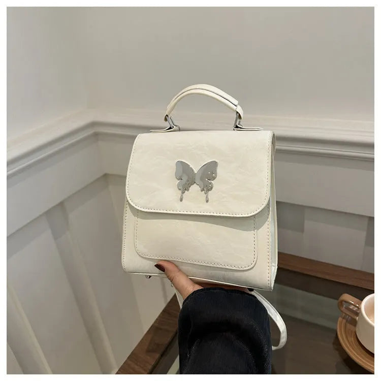 Women's preppy style PU hand-carry backpack with bow detail in light blue colour