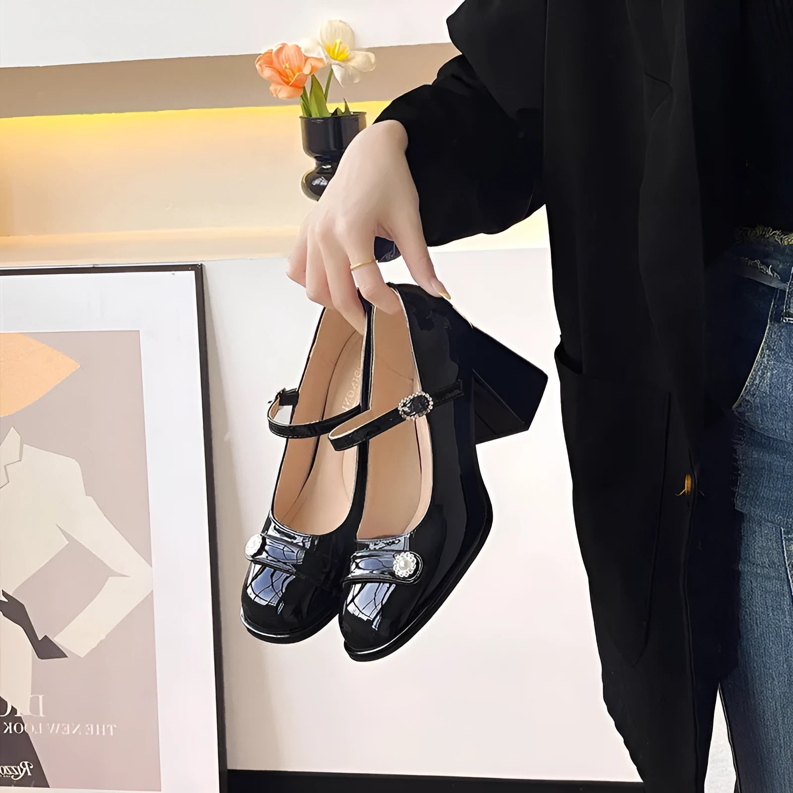 Women's black patent leather round toe chunky heels with a buckle strap, shown in a widened fit style.