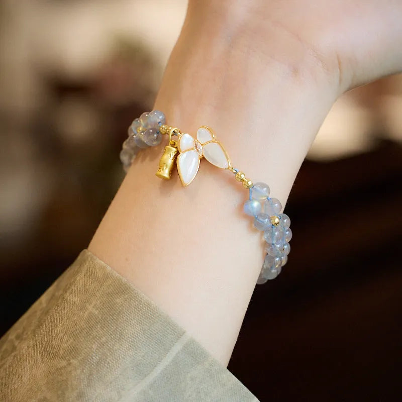 Gray moonstone woven bracelet with geometric design on woven hand rope