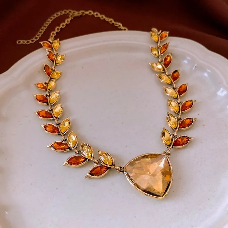 Retro exaggerated alloy clavicle chain necklace with flower pendant and wheat detailing in golden brown