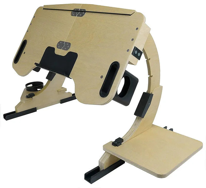 White maple wooden folding computer table with adjustable angle, set on a bed.