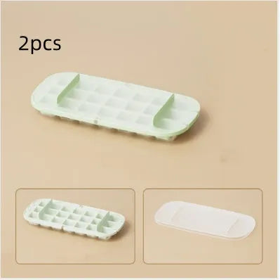 Food-grade plastic ice cube tray with grid design and integrated ice shovel storage in blue.