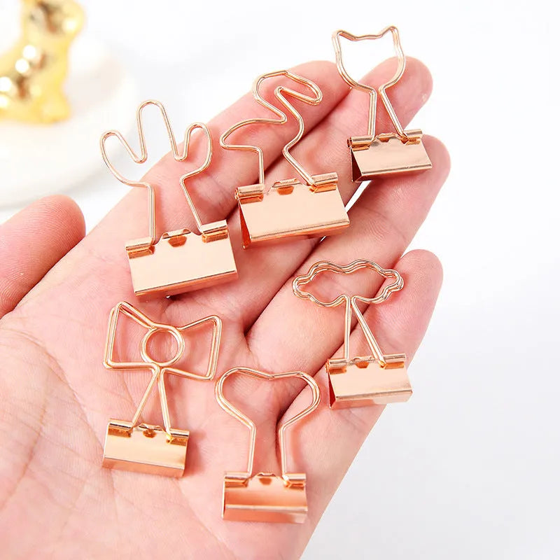 Gold-toned long tail metal office clip with decorative flamingo, love, clouds, cat, cactus, and bow design options.