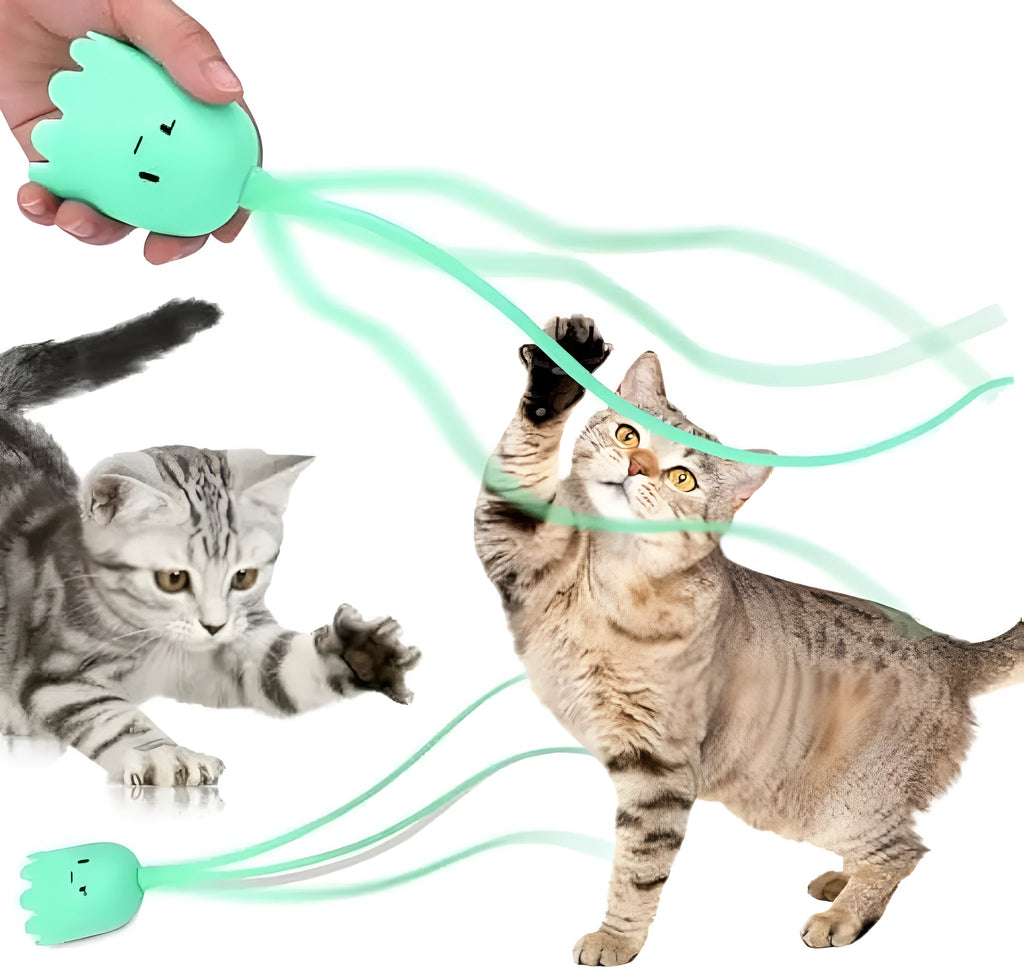 Green rechargeable automatic electronic cat wand toy with swinging silicone tail on a wooden floor