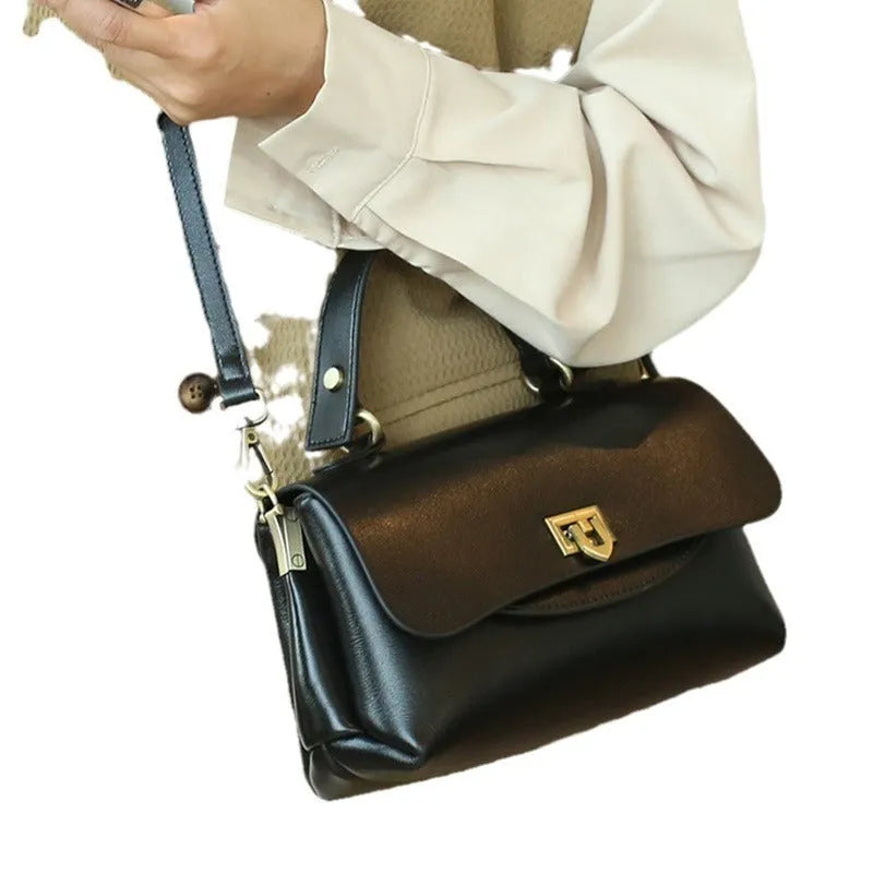 Dark brown women's saddleback leather handbag with double straps and an open front pocket.