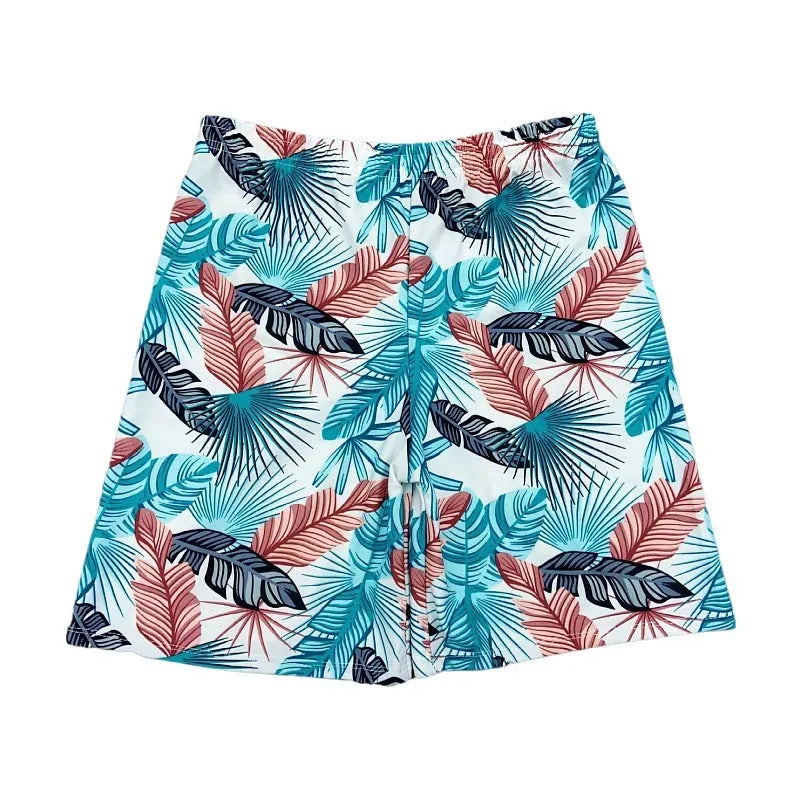 Men's cropped beach swimming trunks in a multicolour leaf pattern, briefs style