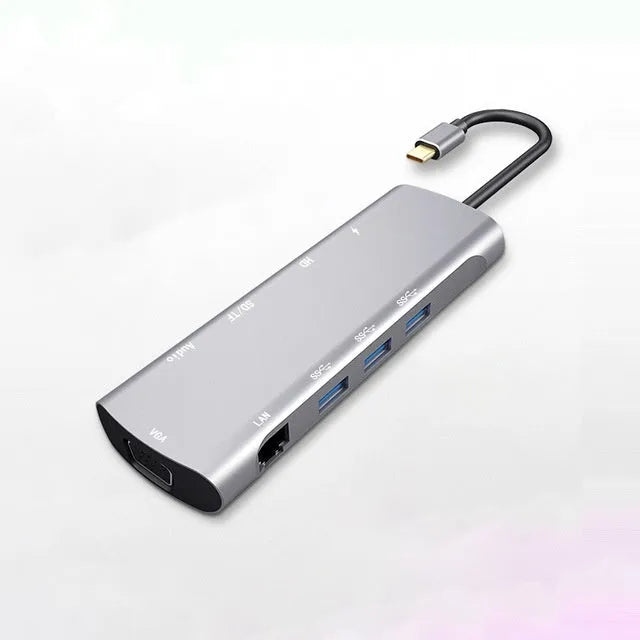 Grey aluminium USB-C docking station with HDMI, VGA, and USB ports.