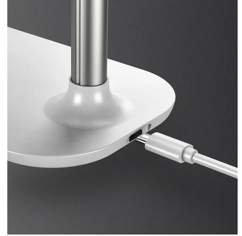 Folding phone holder in black with wireless charging support, shown open on desk