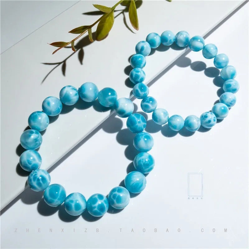 Blue Maillard style bodhi bracelet with natural crystal, sea-pattern stone, and pearls on a white background.
