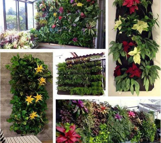Green vertical felt wall planter with multiple planting pockets hanging on a fence, filled with herbs.