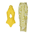 Women's halter neck one-piece swimsuit with matching wrap skirt in solid colour
