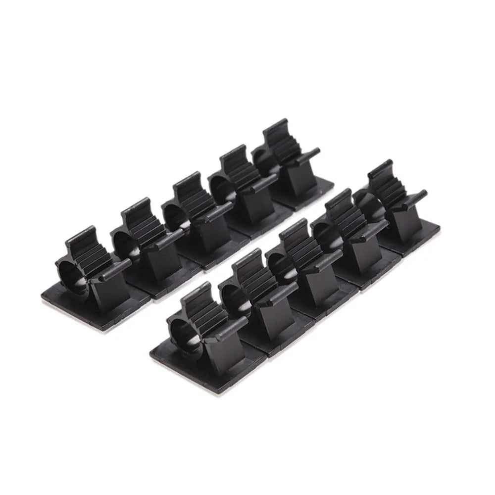 Black nylon adhesive cable clamps on a white background, showing self-adhesive backing and two-stage lock design.