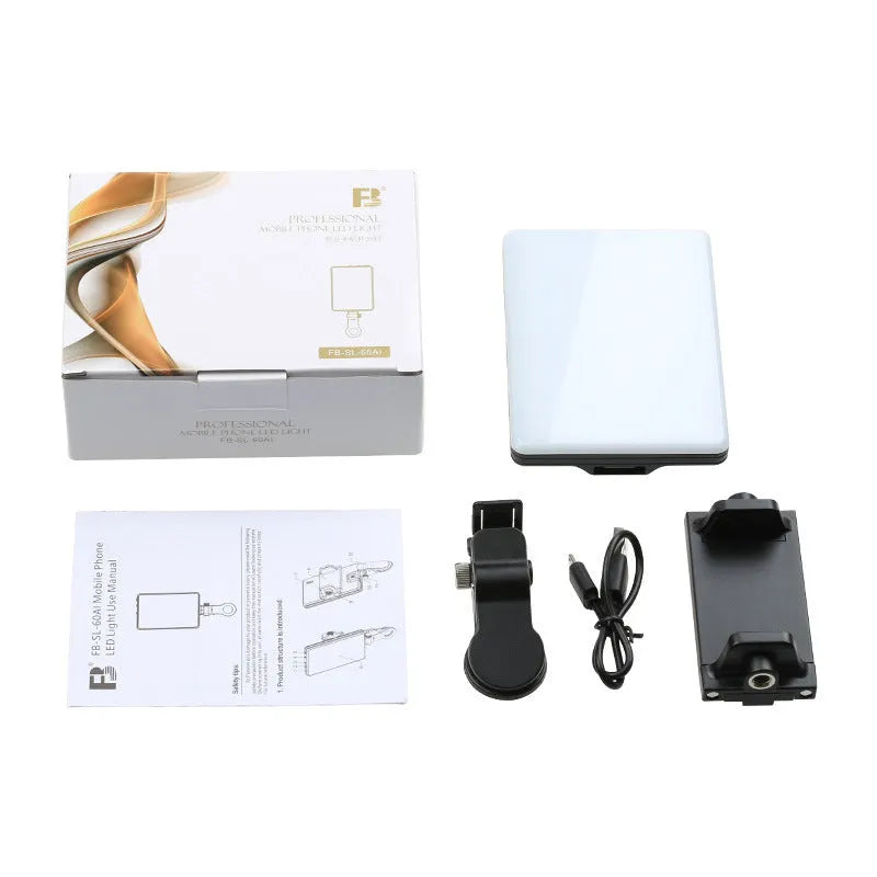 White portable LED fill light clipped to mobile phone with adjustment knob visible