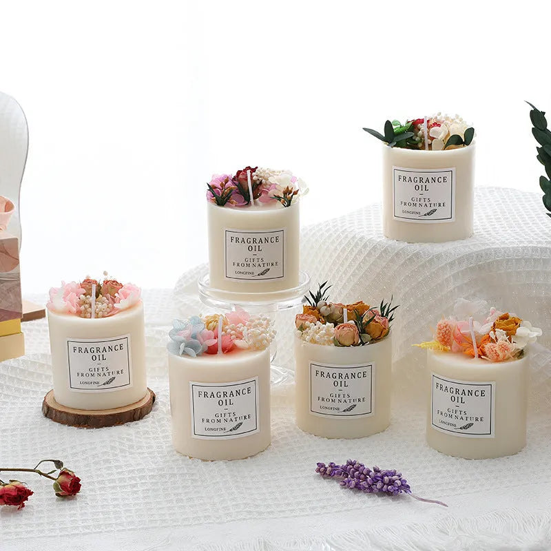 Decorative aromatherapy candle with dried flowers on surface, shown in gift box with chip base.