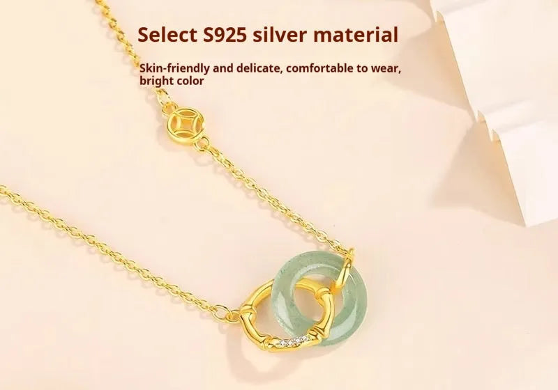 Sterling silver bamboo joint peace buckle necklace on an adjustable O-ring chain with a geometric pearl detail.