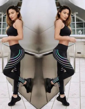 Women's black high-waisted workout leggings with night glowing print pattern on legs