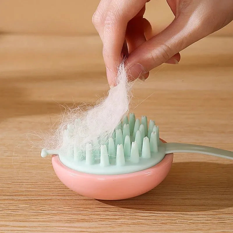 Blue silicone pet bathing brush with soft bristles and ergonomic handle for cats and dogs.