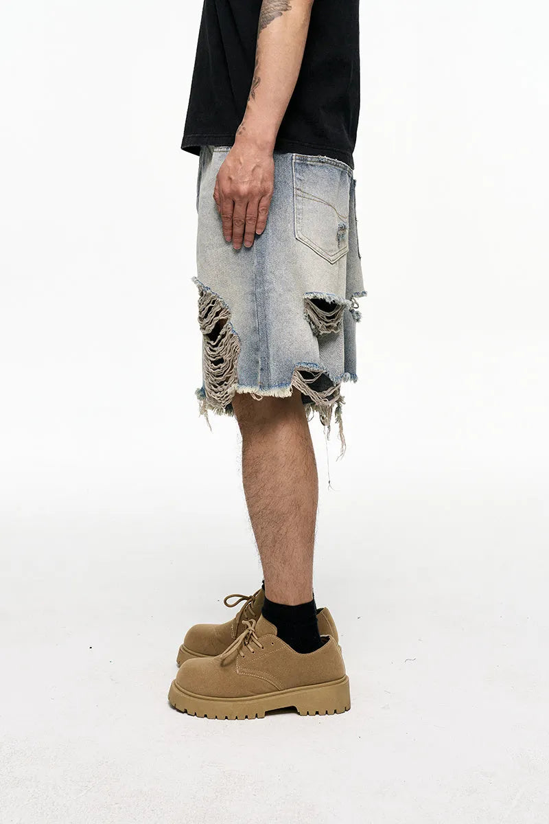 Men's light blue baggy denim shorts on a neutral background, showing wide leg and mid waist.