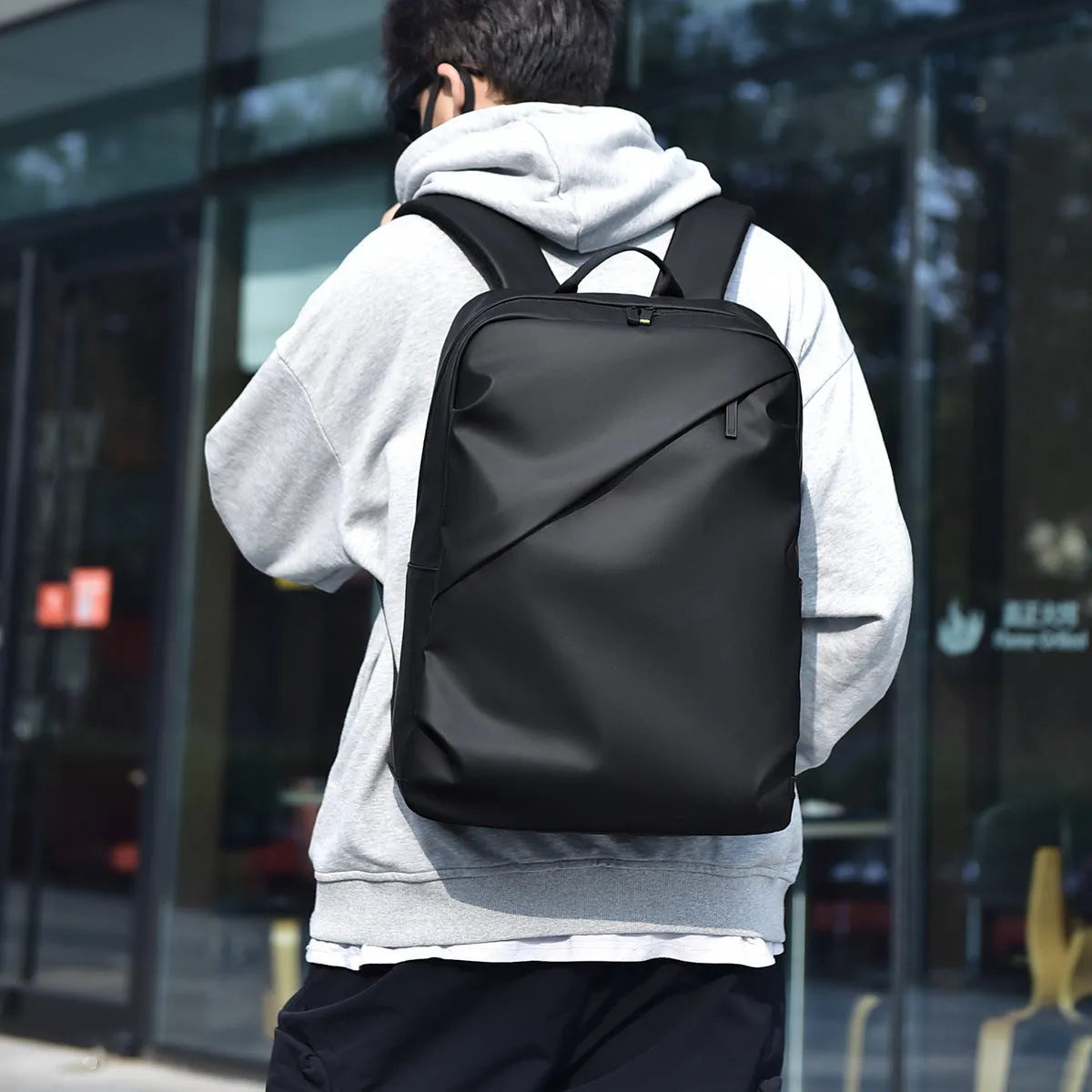 Waterproof PU leather backpack with laptop compartment in black, blue, and grey colour options