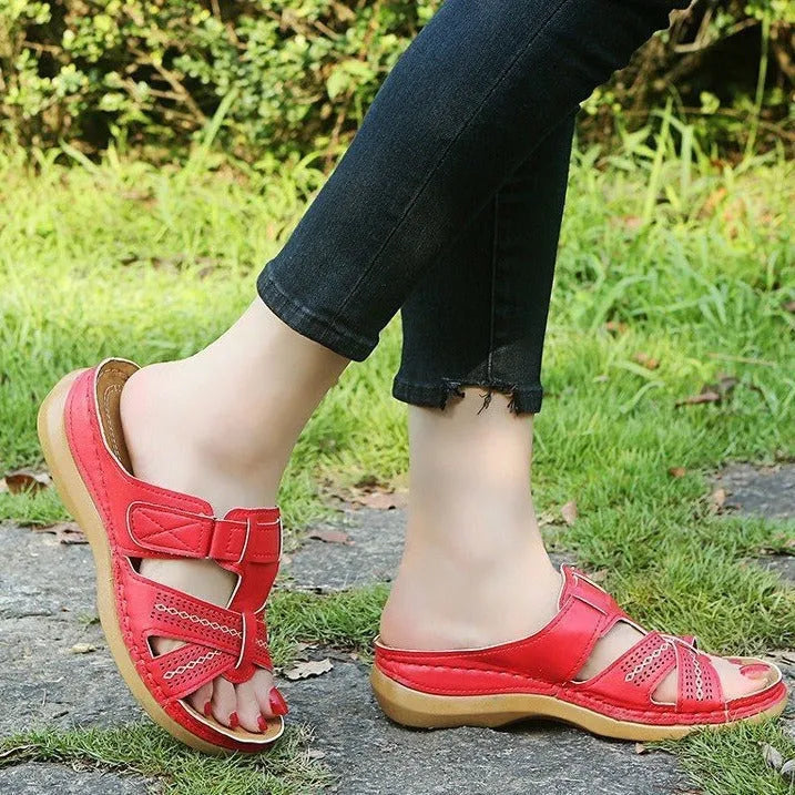 Women's black wedge sandals with a peep toe and Velcro fastening strap on a white background.