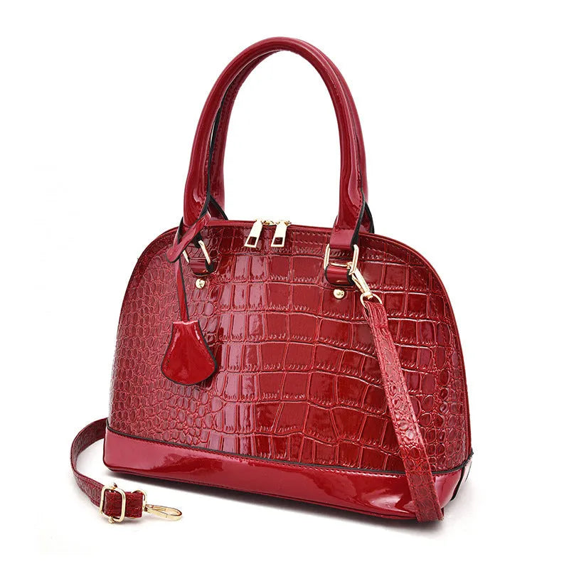 Shiny PU leather shell-shaped crossbody bag in black with dimensions 22x30x15cm