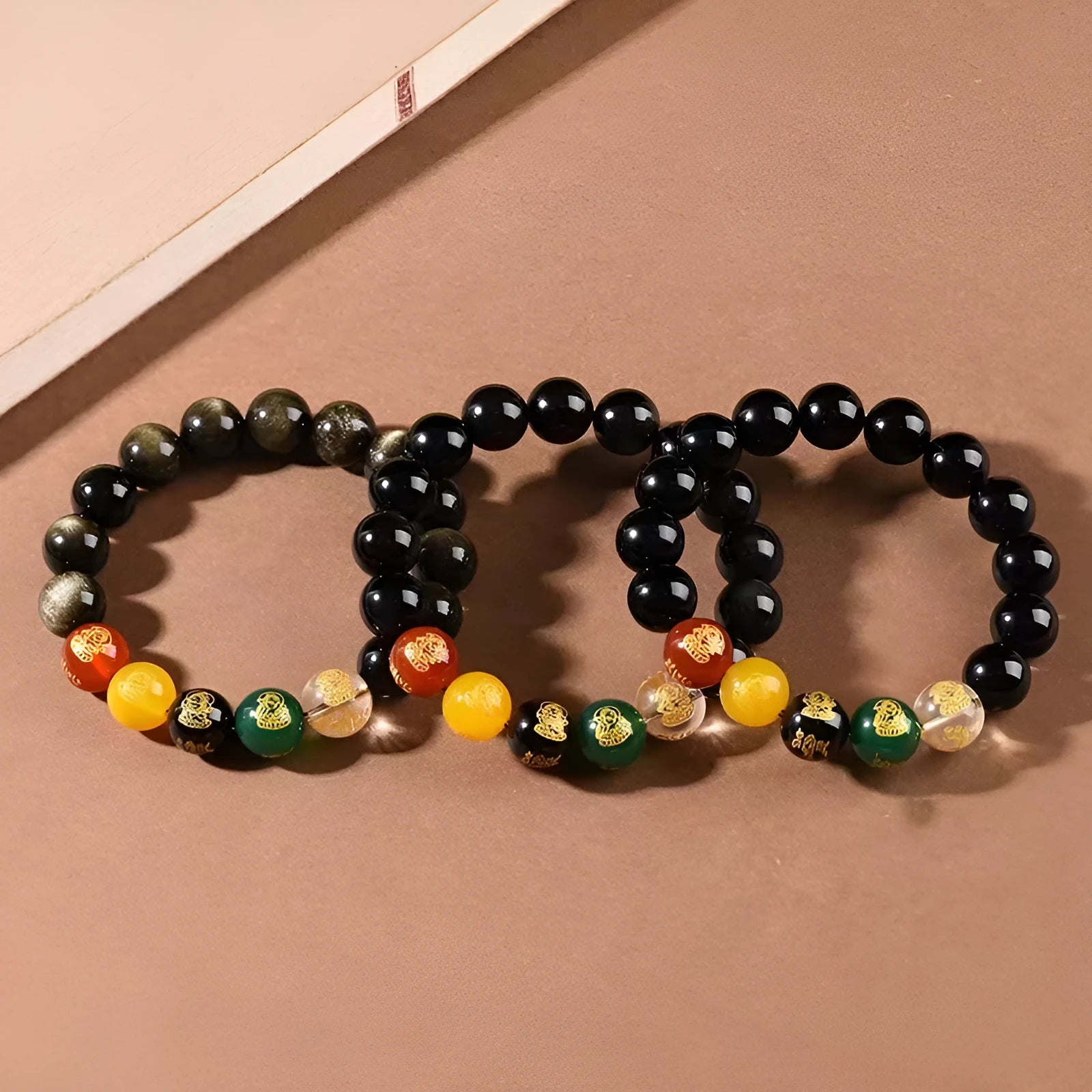 Single circle five gods of wealth bracelet with rainbow eye obsidian beads and zodiac modelling.