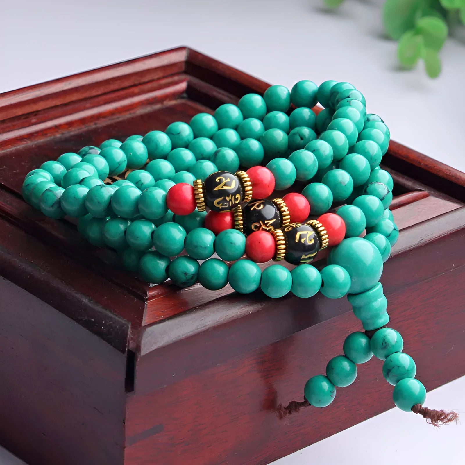 Turquoise 108-bead mala bracelet with polished round synthetic stone powder beads.