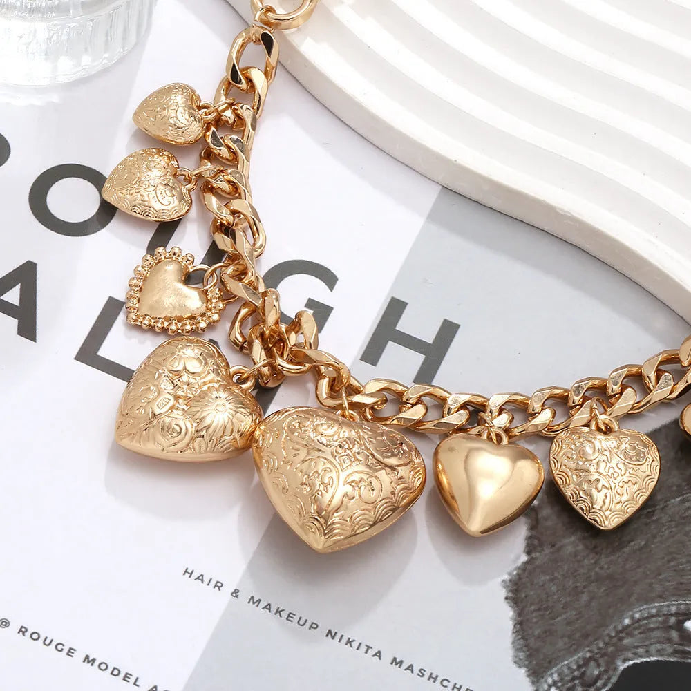 Close-up of a women's exaggerated carved heart pendant necklace on an adjustable metal chain.