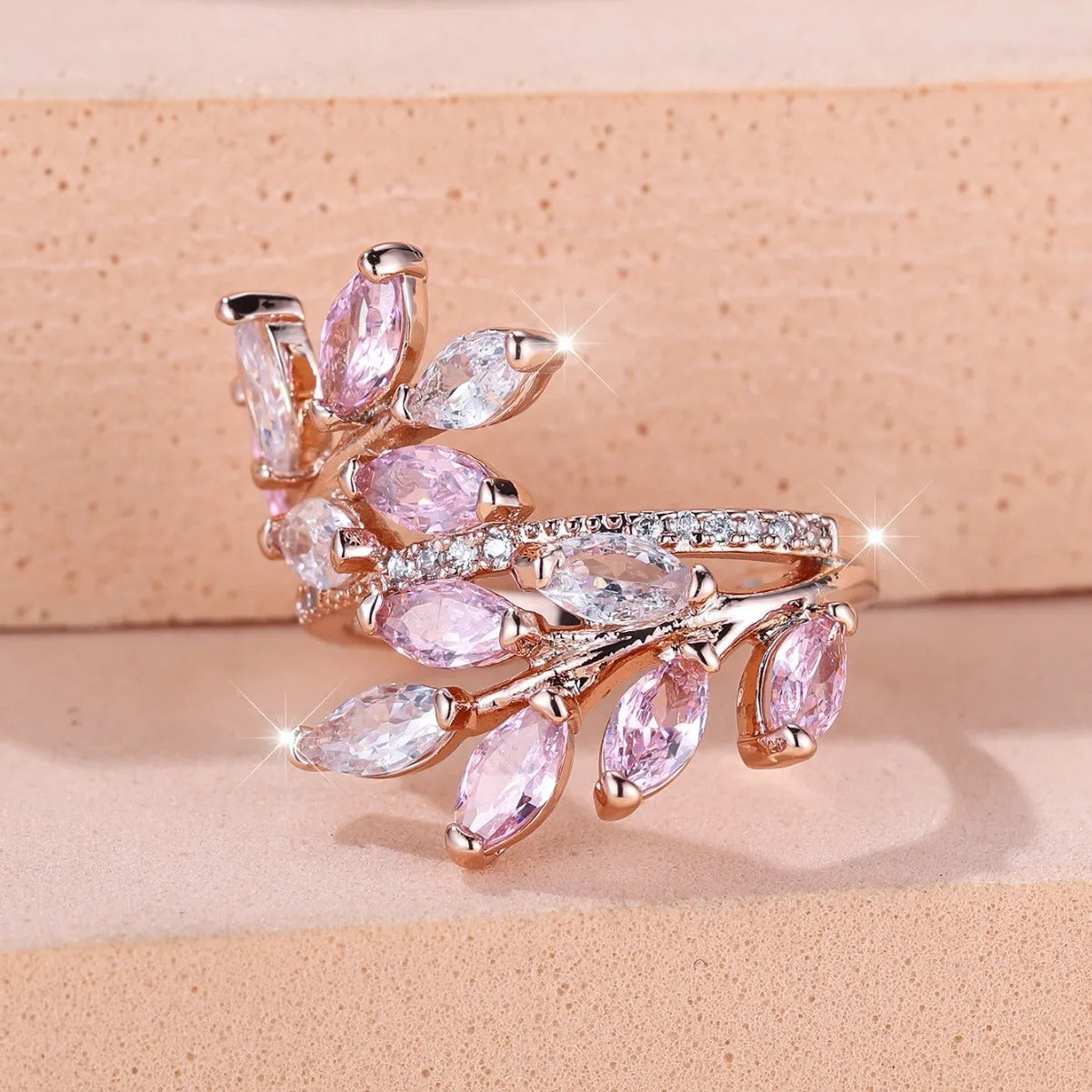 Copper leaf-shaped ring with horse eye design and zircon stones on a finger, showing adjustable opening.