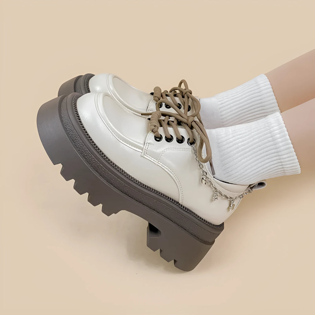 White platform Mary Jane shoes with chunky heel and front lace-up closure