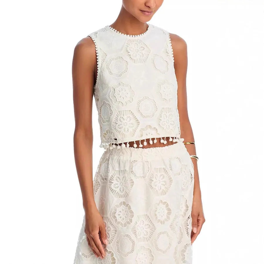White women's polyester two-piece suit with embroidered detailing, featuring a sleeveless top and a long skirt.