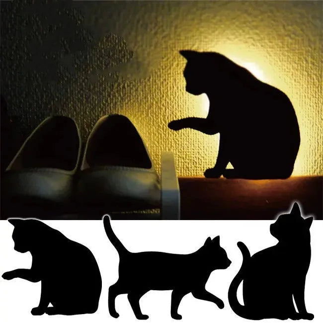Cat-shaped LED night light with sound sensor on a wall, emitting warm yellow light.