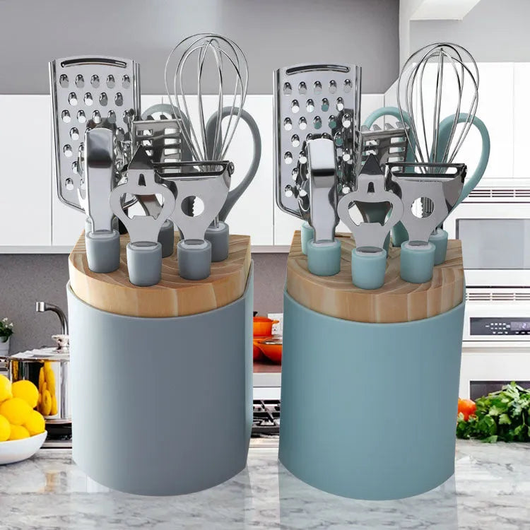 Stainless steel kitchen gadget set with peeler and whisk on grey tray