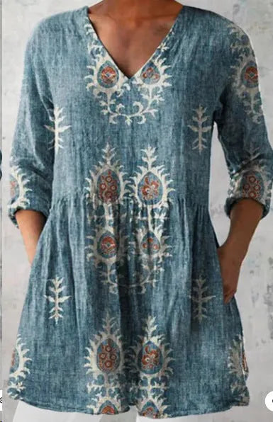 Women's loose-fitting long dress with a blue wave pattern print and 3/4 sleeves.