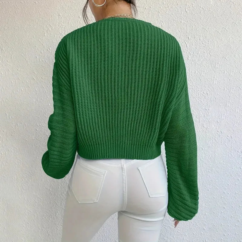 Woman wearing a solid colour long sleeve loose fit casual polyester pullover.
