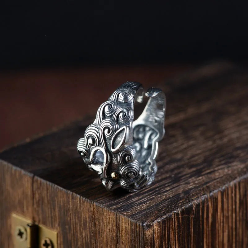 Silver open ring with jibeast pattern and diamond accents showing zodiac animal design