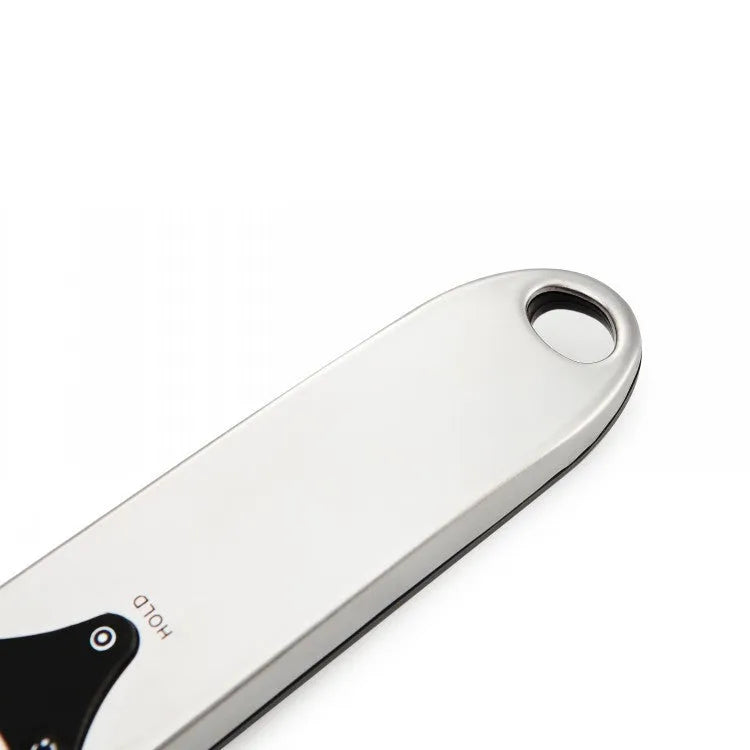 Smart digital measuring spoon with integrated display showing weight, next to AAA batteries.