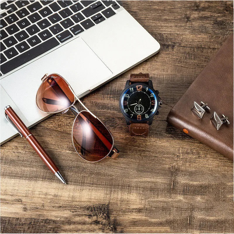 Men's gift set with brown leather watch, sunglasses, pen, and cufflinks in a gift box