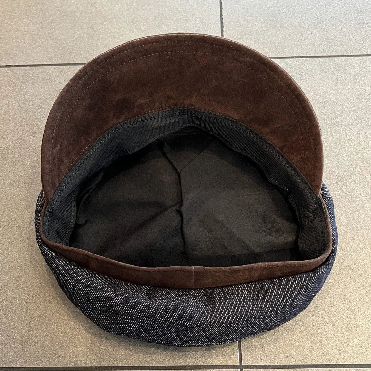 Dark blue denim octagonal newsboy hat with an adjustable fit for 54-58cm head sizes.