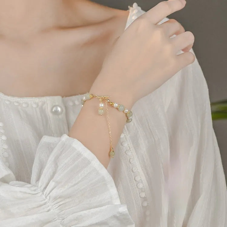 Women's bracelet with round Hetian jade pendant on gold-tone electroplated chain, Chinese-style design