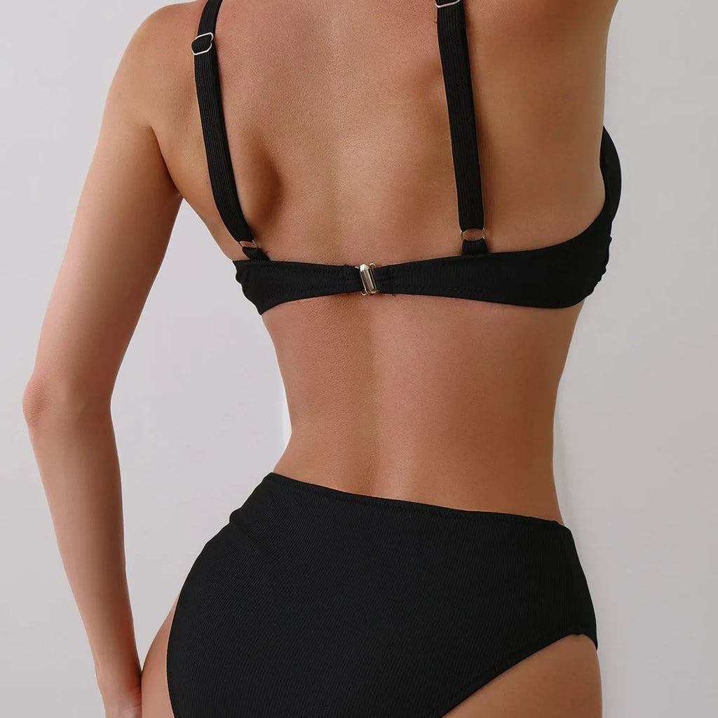 Women's black ribbed texture two-piece bikini set on a mannequin, showing briefs style.