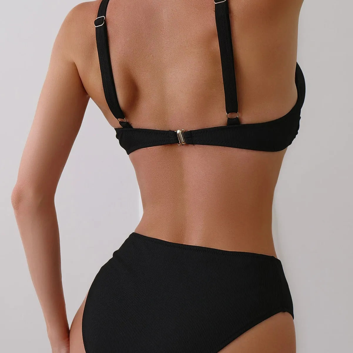 Women's black ribbed texture two-piece bikini set on a mannequin, showing briefs style.