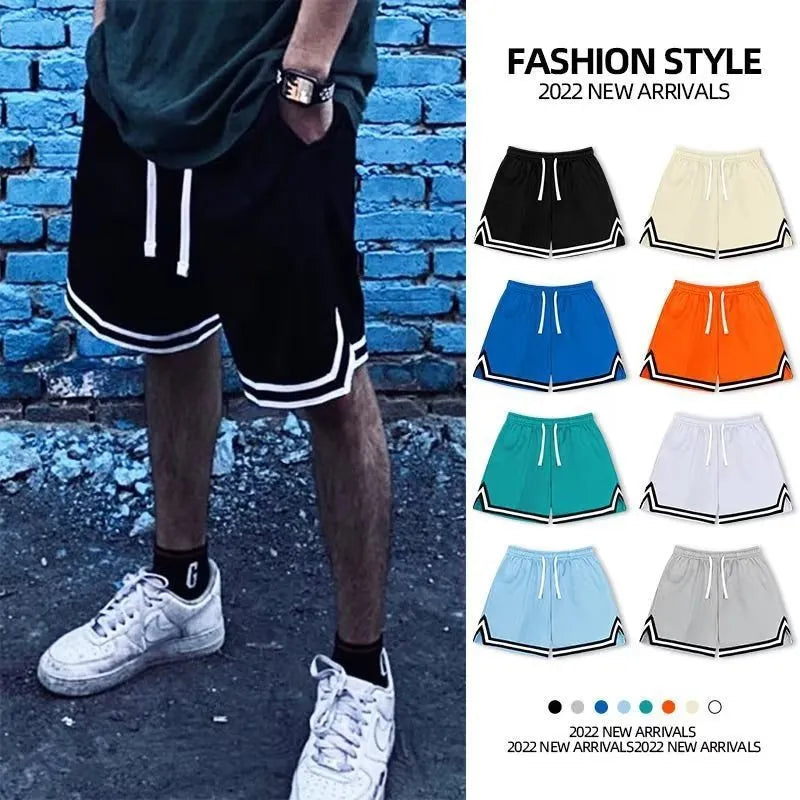 Men's loose-fit polyester sports shorts in apricot colour on a grey background.
