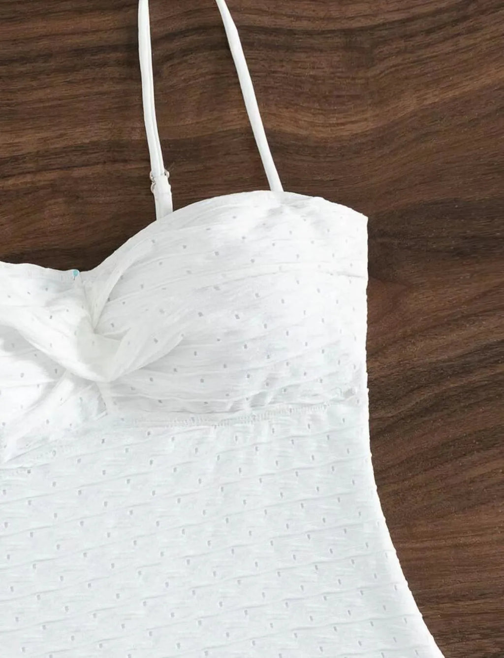 White one-piece swimsuit for women with sling back and briefs cut on a mannequin