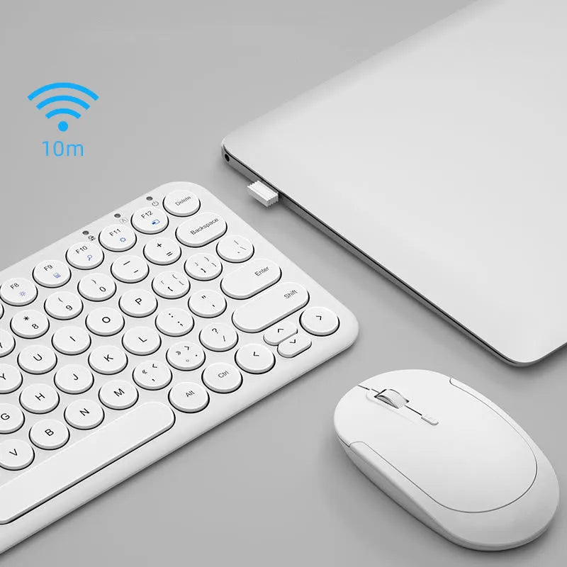 Mute ultra-thin wireless white keyboard and mouse set with USB receiver on a desk.