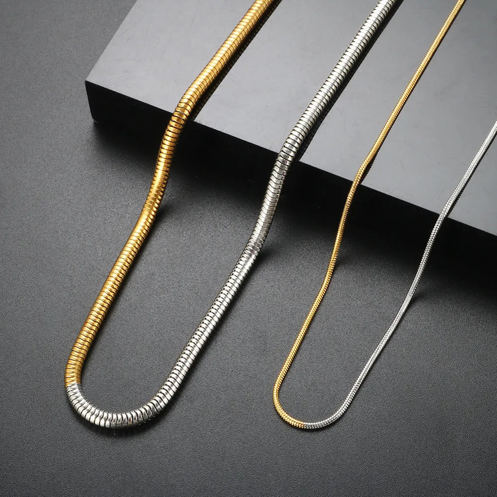 Gold-colour women's snake bones chain necklace with geometric alloy pendant, 3mm wide.