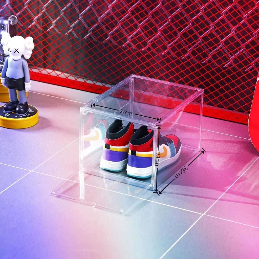 Clear acrylic shoe storage box with magnetic side door open, showing shoes inside.