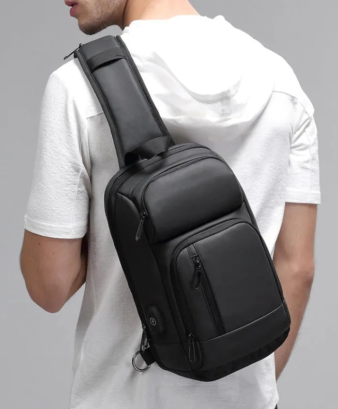 Black PVC outdoor shoulder bag showing internal laptop pocket and air cushion shoulder strap.